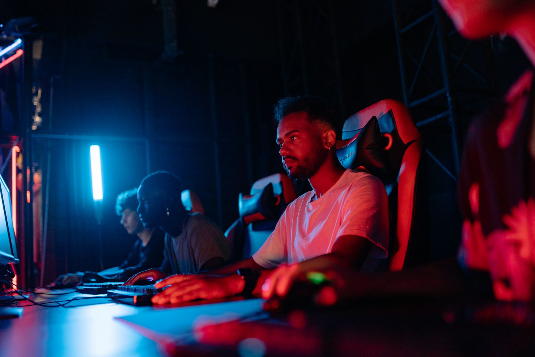 A gamer playing a video game in a darkened room, representing dedicated Fallout fans returning to older titles