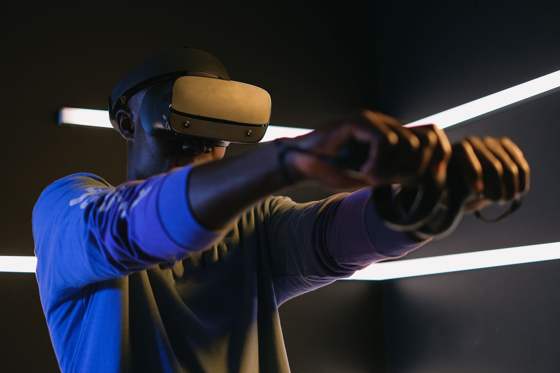 A person wearing a VR headset while playing an immersive game