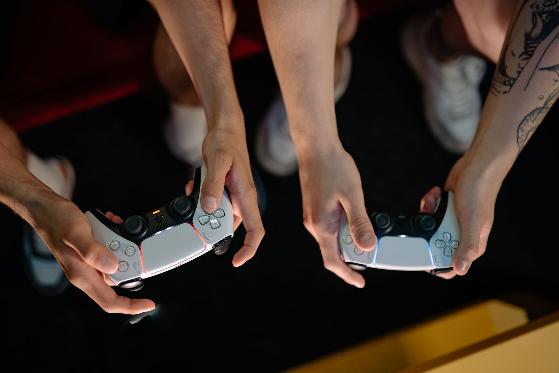 Player holding a gaming controller with focus on hands and buttons